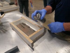 Spraying mold release on manufactured stone