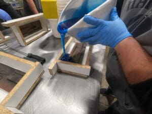 Pouring liquid rubber into manufactured stone mold